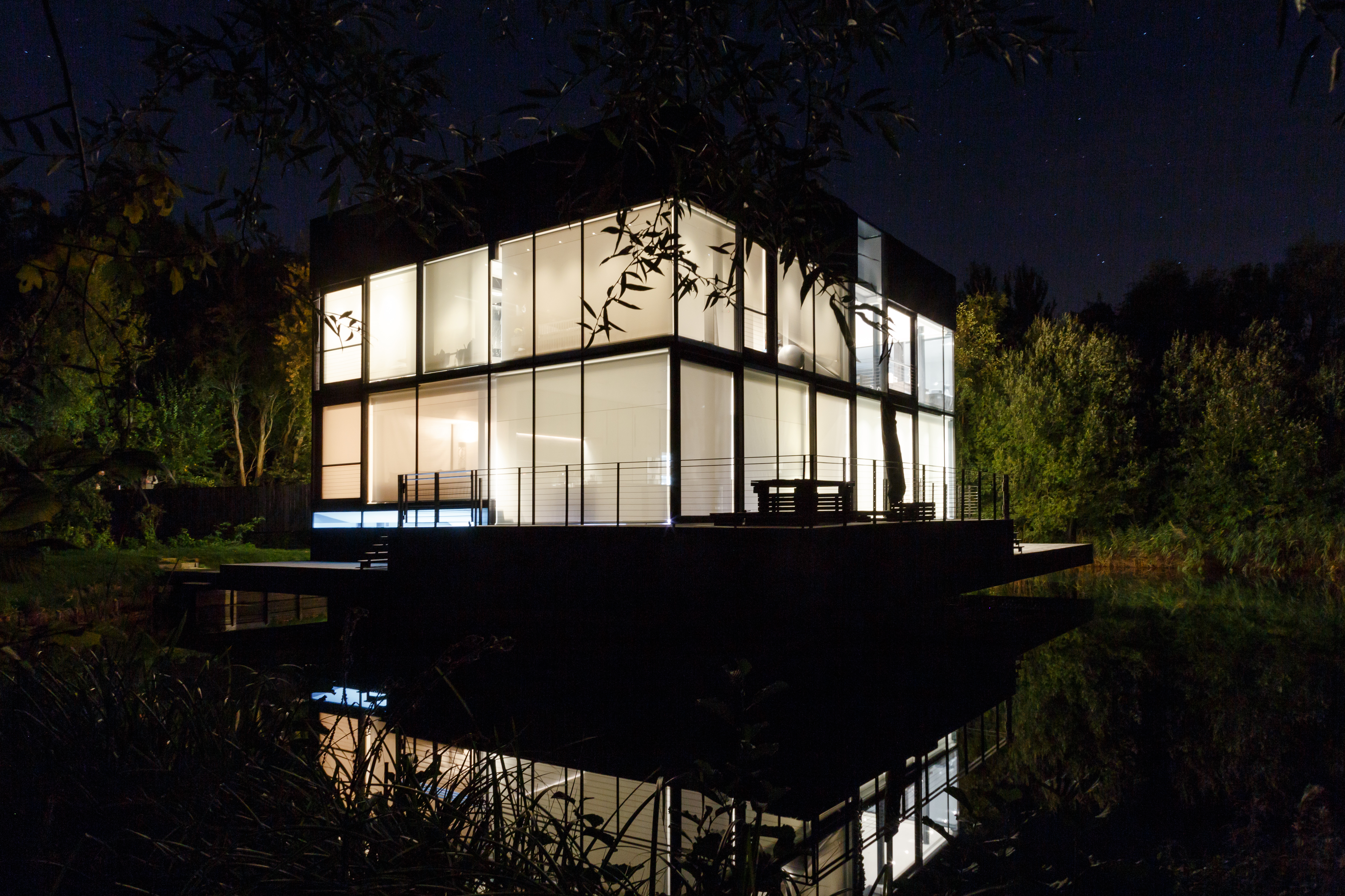 The Glass House illuminated at night - home automation and smart lighting