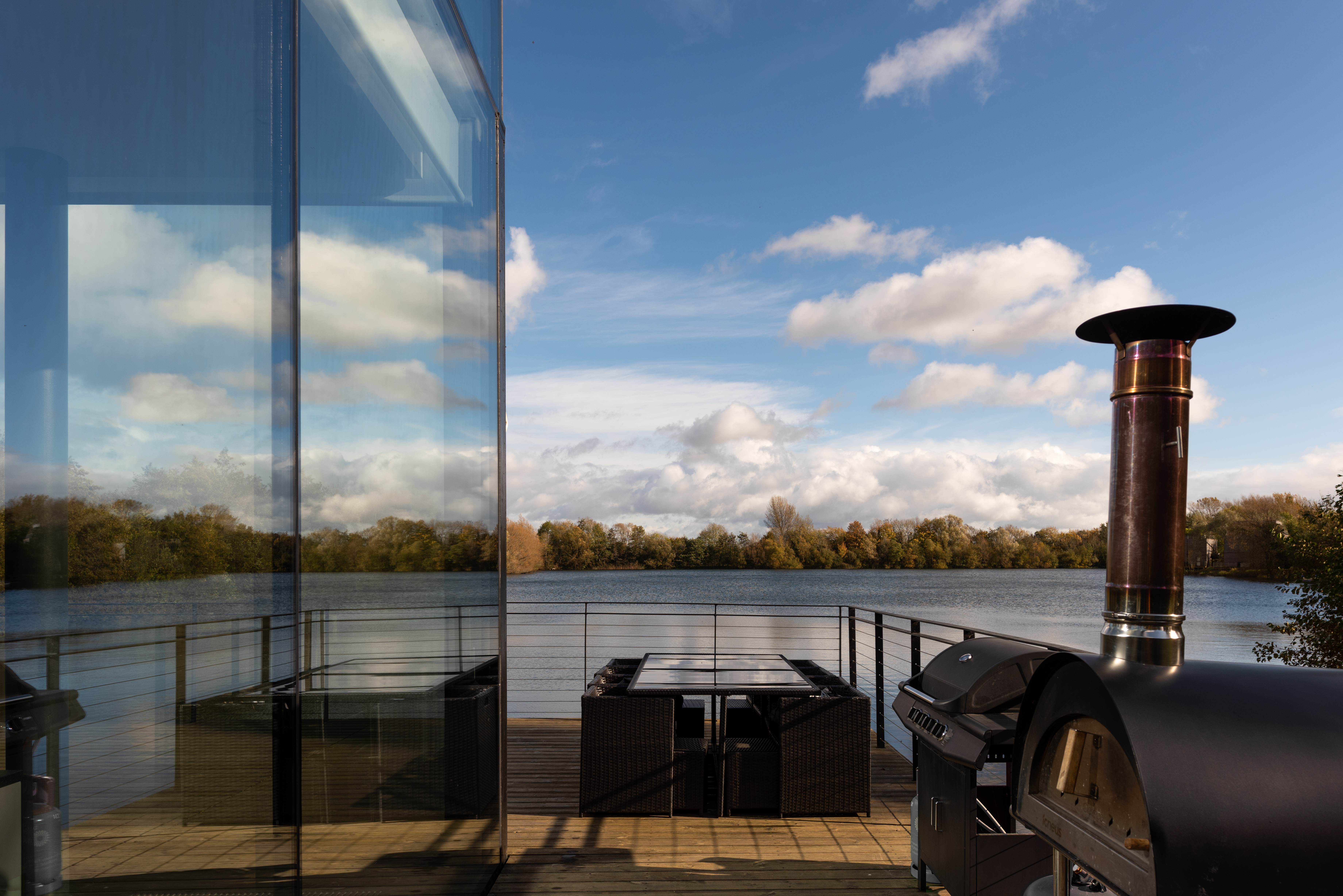 Morning light streaming through the Glass House - lake reflections at dawn